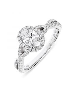 Platinum oval cut diamond set in oval halo with brilliant round cut diamond shoulders. 0.60cts